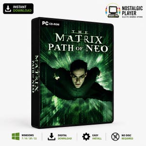 Puede incluir: Una caja de juego PC CD-ROM para The Matrix: Path of Neo. La portada muestra a una persona con abrigo negro y gafas de sol volando hacia adelante sobre un fondo de código digital verde. El título está impreso en blanco en la parte superior.