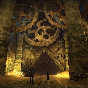 May include: A cavernous interior space featuring massive, weathered stone gears mounted on the ceiling above a triangular entryway. The walls are constructed from textured, stacked stone blocks in shades of brown and green, illuminated by warm, golden light sources.