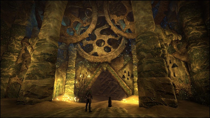 May include: A cavernous interior space featuring massive, weathered stone gears mounted on the ceiling above a triangular entryway. The walls are constructed from textured, stacked stone blocks in shades of brown and green, illuminated by warm, golden light sources.