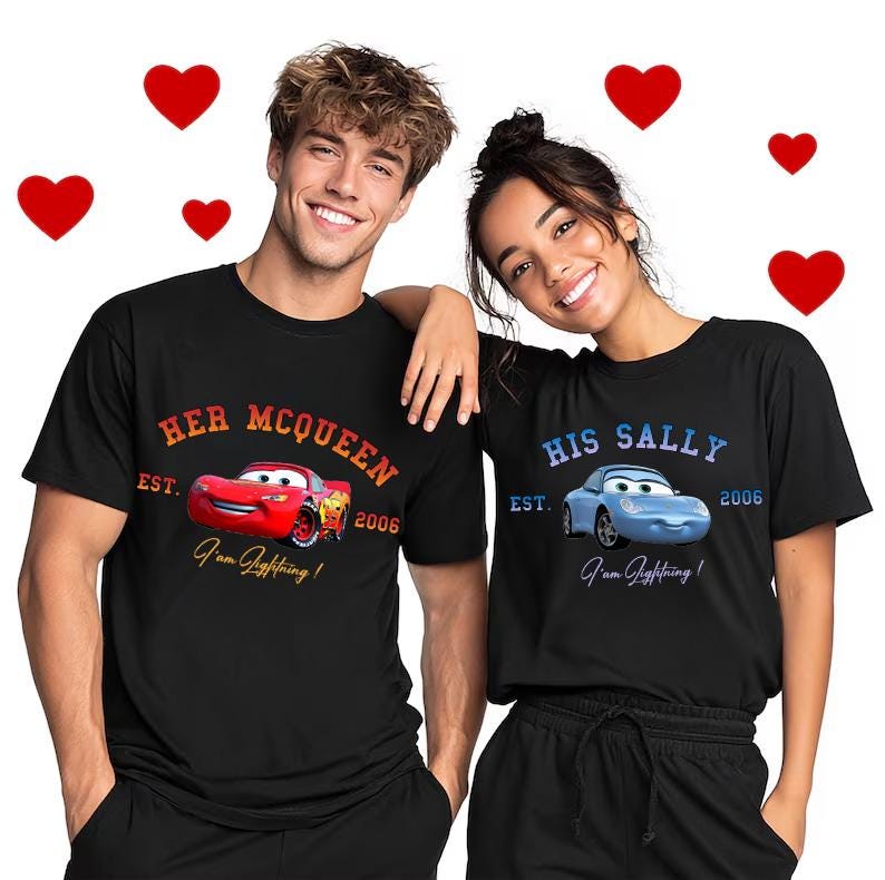 May include: Black t-shirts with car graphics. One shirt says "Her McQueen" with a red car, and the other says "His Sally" with a blue car. Both shirts have the text "I'm Lightning!" and the year 2006.