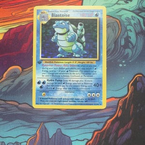 May include: A Blastoise Pokémon card featuring a blue turtle-like creature. The card has a blue and yellow border with text describing the character's abilities and stats. The card is on a colorful background.