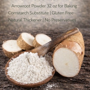 May include: A wooden spoon filled with white arrowroot powder sits next to a cut arrowroot root. The image includes text that reads "Arrowroot Flour 2 LB" and "Arrowroot Powder 32 oz for Baking".