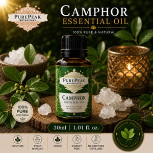 May include: A 30ml bottle of Camphor Essential Oil from PurePeak Botanicals. The bottle has a green label and black cap. The image includes the text "100% Pure & Natural" and "Therapeutic Grade". The image also shows crystals and a lit candle. The bottle is 1.01 fl oz.