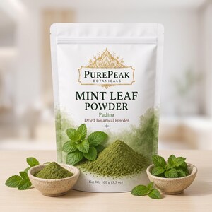 May include: A white stand-up pouch of PurePeak Botanicals Mint Leaf Powder, labeled Pudina and Dried Botanical Powder, with a net weight of 100 g (3.5 oz). The packaging features green mint leaves and a pile of green powder in small bowls.