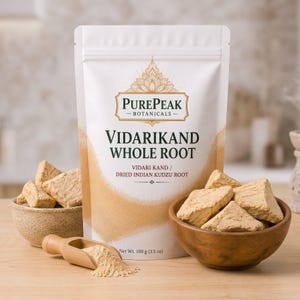 May include: A white stand-up pouch labelled PurePeak Botanicals Vidarikand Whole Root, also identified as dried Indian kudzu root. The package displays a net weight of 100 g. Beside it are two wooden bowls filled with root chunks and a small wooden scoop.