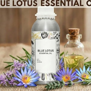 May include: A silver bottle labeled "BLUE LOTUS ESSENTIAL OIL" stands beside a small glass bottle with a cork stopper. The bottles are surrounded by blue lotus flowers, purple flowers, and green sprigs. The background is a light brown.