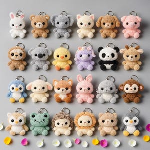May include: A collection of twenty-four crocheted animal keychains in various colors. The keychains include a white bunny, brown bear, gray elephant, yellow cat, brown dog, pink pig, brown sloth, gray koala, yellow chick, purple sheep, black and white panda, and brown deer.