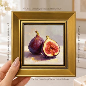 May include: A framed oil painting of two figs, one whole and one halved, showcasing the fruit's deep purple skin and red interior. The painting is in a gold frame. Text on the frame reads: "Available in multiple sizes and frame styles" and "Original hand-painted oil painting."