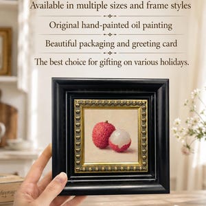 May include: A framed oil painting of two lychees, one whole and one halved, with a black frame and gold inner border. The painting is displayed against a neutral background. Text above the painting reads: "Available in multiple sizes and frame styles".