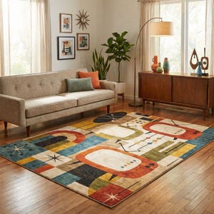May include: A colourful mid-century modern rug featuring a retro television design in orange, beige, blue, and yellow. The rug is placed on a wooden floor in a living room, with a sofa and wooden cabinet visible.