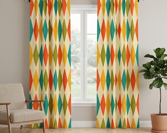 May include: Two floor-length window curtains featuring a repeating diamond pattern in shades of orange, yellow, teal, and olive green on a cream background. The curtains are hung on a black rod and cover the sides of a white window frame.