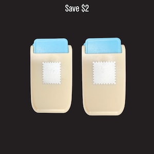 May include: Two beige paper punches with light blue top levers and a square stamp-shaped icon on the front. The text Save $2 is positioned above the two tools, which feature a rectangular body and a mechanism for creating paper cutouts.