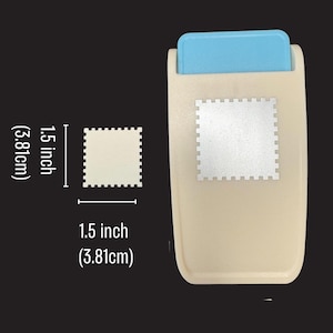 May include: A beige craft punch with a light blue handle, featuring a square shape with scalloped edges. The punch creates a 1.5 inch by 1.5 inch square cutout. The tool is shown next to a square cutout with the same 1.5 inch dimensions.