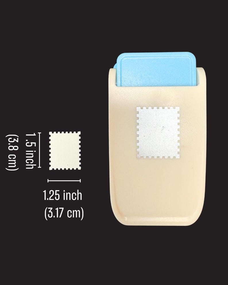 May include: A beige and light blue craft paper punch with a rectangular stamp-shaped cutout design. The punch creates a shape measuring 1.5 inches by 1.25 inches, as indicated by the white measurement labels printed next to the tool.