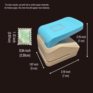 May include: A light blue and beige paper punch with a stamp-shaped cutout design. The tool measures 2.76 inches in height and 2.76 inches in length. The punch creates a 1.13 inch by 0.94 inch shape. Text reads: For best results, use with foil or softer paper materials.