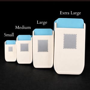 May include: Four rectangular plastic bag sealers in graduated sizes labeled Small, Medium, Large, and Extra Large. Each device features a cream-colored body, a light blue top handle, and a central gray square with a serrated border design.