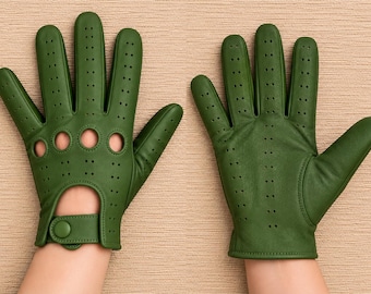 May include: A pair of olive green driving gloves featuring perforated detailing across the fingers and knuckles, with circular cutouts on the knuckles and a wrist strap secured by a snap button closure on one of the gloves.