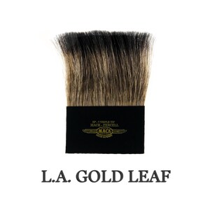May include: A black and gold brush with a black handle and the text "BP-7 TRIPLE TIP MACK-PERCELL MACK BRUSH COMPANY" on the handle. The brush is labeled "L.A. GOLD LEAF".