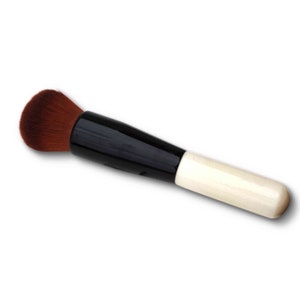 May include: A black and white makeup brush with a brown bristle head. The brush has a black handle and a white wooden tip.