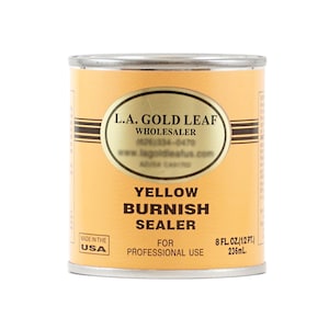 May include: A yellow can of L.A. Gold Leaf Burnish Sealer for professional use. The can is labeled with the company's name, website, and phone number. It contains 8 fluid ounces (236 ml) of sealer.