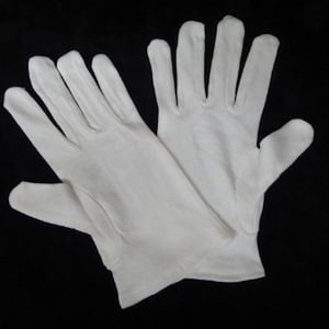 May include: A pair of white cotton gloves. The gloves are made of a soft, smooth fabric and have a simple design.