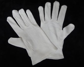 May include: A pair of white cotton gloves. The gloves are made of a soft, smooth fabric and have a simple design.