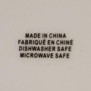 May include: White background with black text that reads "MADE IN CHINA", "FABRIQU&Eacute; EN CHINE", "DISHWASHER SAFE", and "MICROWAVE SAFE". The text is centered and in a sans-serif font.