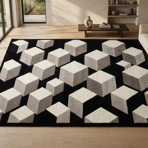 May include: A rectangular area rug featuring a repeating geometric pattern of three-dimensional cubes in shades of cream, light grey, and dark grey set against a solid black background, creating a visual illusion of depth across the surface.