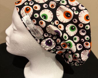 Halloween eyeball printed Euro style scrub hat with orange top and adjustable elastic