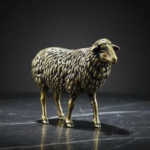 May include: A bronze sheep figurine with detailed wool texture. The sheep stands on four legs, with a slight turn of its head. The background is a dark gradient, highlighting the sculpture's form and metallic sheen.
