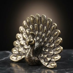 May include: A detailed brass peacock figurine with its tail feathers fanned out. The sculpture has a vintage aesthetic, with intricate detailing on the feathers and body. The peacock is set against a dark background.