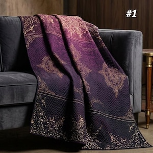 May include: A deep purple quilt featuring a gold-colored intricate filigree pattern and a chevron-stitched texture. The fabric displays a repeating ornate design across its surface, with the number 1 visible in the upper right corner of the image.