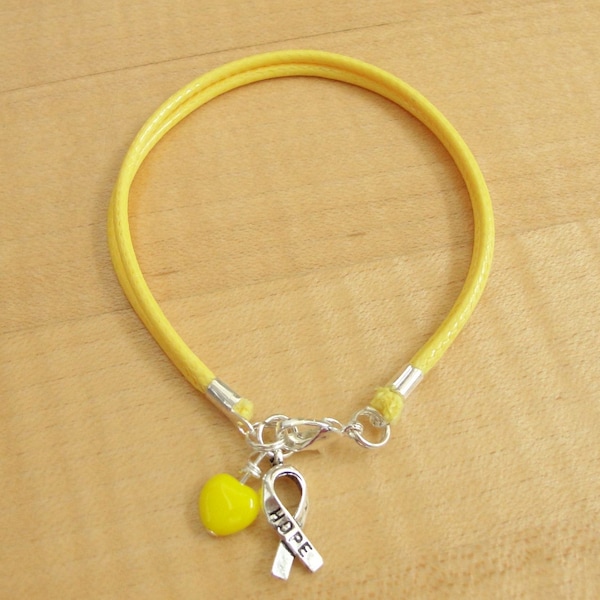 Pulsera amarilla de algodón para concienciar sobre la endometriosis, la espina bífida, el cáncer de vejiga, las enfermedades hepáticas y el sarcoma de Ewing.