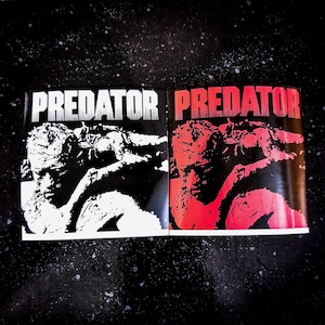May include: Two copies of a magazine with the word "PREDATOR" in bold white letters at the top. One magazine is black and white, the other is red and black. The image features a stylized illustration of a person.