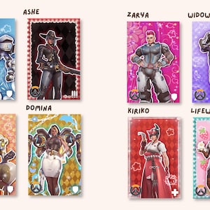 May include: A collection of eight rectangular character cards featuring Overwatch heroes Sigma, Ashe, Zarya, Widowmaker, Zenyatta, Domina, Kiriko, and Lifeweaver. Each card displays a unique background color, pattern, and role icon, with the character name printed above each individual card.