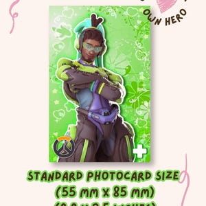May include: A rectangular trading card featuring a character in a green and purple futuristic suit with headphones, set against a green floral background. The text CHOOSE YOUR OWN HERO and a heart are visible. Dimensions are 2.2 inches by 3.5 inches.
