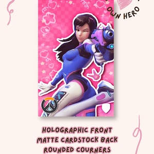 May include: A rectangular card featuring a character with long dark hair in a blue and pink suit holding a pink blaster. The background is pink with a checkered pattern, hearts, and stars. Text reads CHOOSE YOUR OWN HERO, HOLOGRAPHIC FRONT, MATTE CARDSTOCK BACK, ROUNDED COURNERS, HANDMADE!