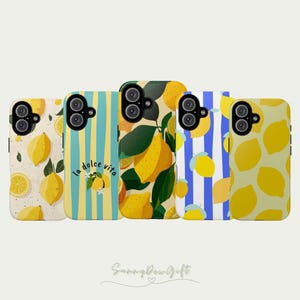 May include: Five phone cases with lemon designs. The cases feature various patterns, including lemons on a cream background, blue and yellow stripes, and lemon illustrations with green leaves. The phrase "la dolce vita" is on one case.