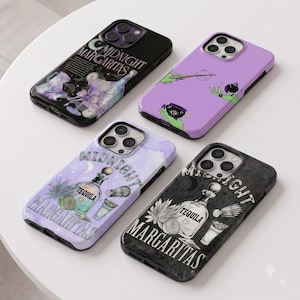 May include: Four smartphone cases featuring designs related to Midnight Margaritas. One black case with a cocktail illustration, one purple case with witchy graphics, one light purple watercolor case, and one dark grey case with tequila art.