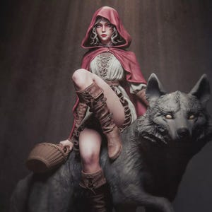May include: A figurine depicting a woman in a red hooded cloak and dress, seated on a grey wolf. She wears brown boots and holds a woven basket. The wolf has yellow eyes. The background is a dark, neutral tone.