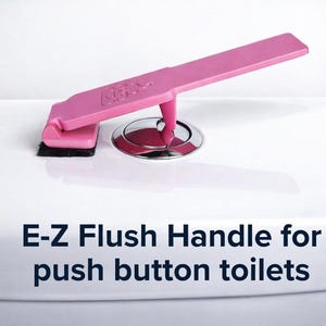 May include: Pink E-Z Flush Handle for push button toilets. The handle is a vibrant pink color and is designed to replace a standard toilet flush handle. The handle is mounted on a white toilet.