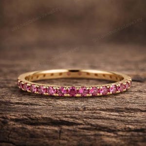 May include: A white ceramic mug with a black handle and the text "But First, Coffee" in a bold, black font. The mug is set against a blurred background, highlighting its clean design.