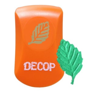 May include: An orange Decop leaf-shaped paper punch with a green leaf cutout. The punch features a circular design with a leaf graphic. The word "DECOP" is printed in white on the punch.