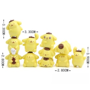 A group of yellow cartoon animal figurines, including a dog, cat, and other small animals, arranged in a row.