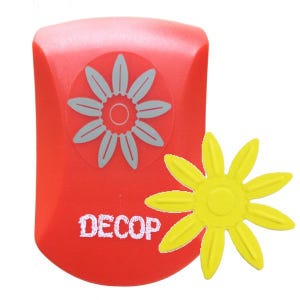 May include: A red craft punch with a daisy design and the word "DECOP" printed on the front. A yellow daisy is punched out and sits next to the punch. The daisy punch is a crafting tool for paper and other materials.
