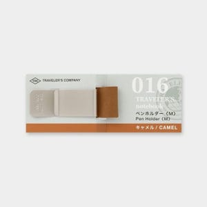 May include: A Traveler's Company notebook pen holder in camel color. The pen holder is beige and brown, with the text "TRAVELER'S COMPANY" and "016" visible. The packaging also includes Japanese text.