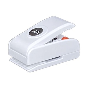 May include: A white paper punch with a black circular button that reads "1/2". The punch has a lever and a red button. The base of the punch has a ridged design.