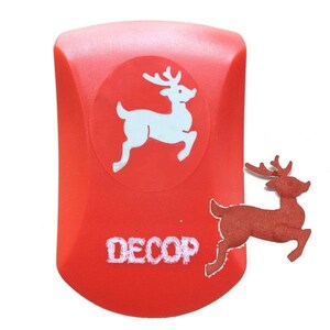 May include: A red craft punch with a white reindeer design and the word "DECOP". A separate, die-cut reindeer is next to the punch. The punch is a crafting tool for creating decorative shapes.
