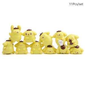 A collection of yellow cartoon animal figurines, including dogs and cats, arranged in a row.