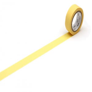 May include: A roll of solid light yellow washi tape with a smooth matte texture. The inner cardboard core of the roll features the repeating black text mt printed along the inner rim, with a strip of the yellow tape extending outward from the roll.